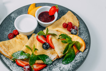 pancakes with strawberries, raspberries and jam, breakfast, healthy food isolated on white background