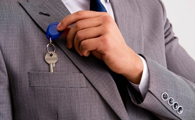 Businessman in real estate concept with home key