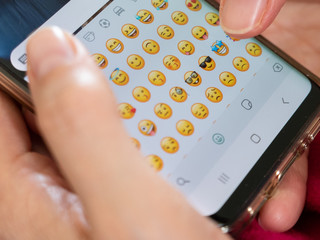 woman sends funny emoticons on an instant messaging application