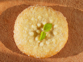 One sugar cookie on a wooden background close-up. View from above.
