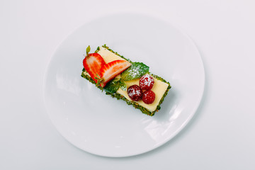 Dessert, fruit cake with mint berries isolated on white background