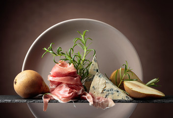Prosciutto or spanish jamon with blue cheese, pears and rosemary.
