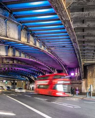 Foto op Plexiglas Double decker red bus on the road under the bridge passage in London © cristianbalate