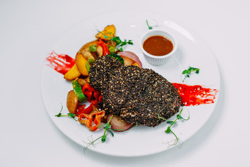pepper steak with grilled vegetables with sauce on an isolated white background
