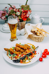 breaded chicken with stuffed eggplant and pepper on an isolated white background