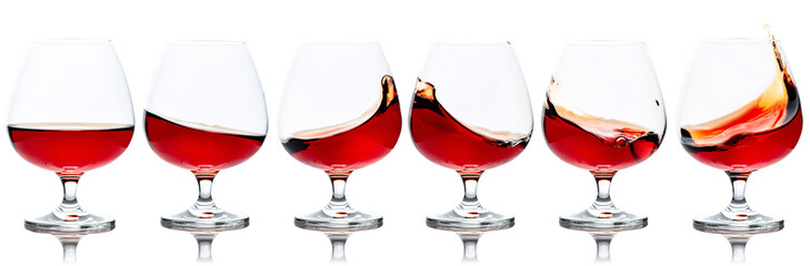 Set of brandy snifters with splashes.