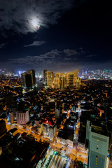 Fototapeta na wymiar Manila city view at night from a skyscraper while the moon shines