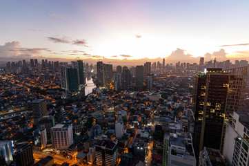 Manila city view at night from a skyscraper while the sun rises