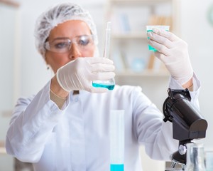 Fototapeta premium Woman chemist working in hospital clinic lab
