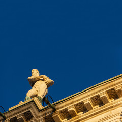 Lower view of the Ionic-inspired entablature of the Palladian Basilica illuminated by the last ray of sunshine. The building was designed by the architect Andrea Palladio in 1546, Vicenza, Italy.