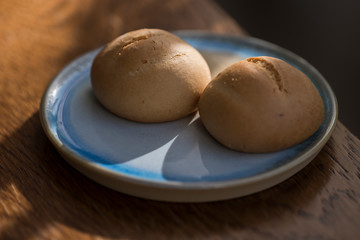 Two Artisanal Mini Cakes on a Rustic Blue Plate - Macro Closeup on Wooden Table