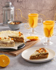 Homemade vegan carrot orange cake with cream  frosting. sea buckthorn tea with oranges.