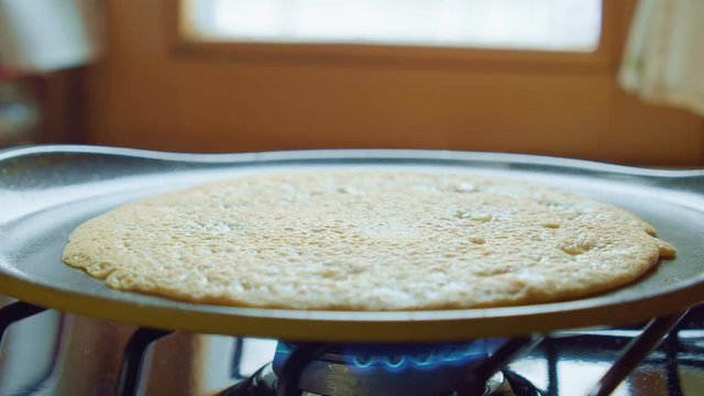 Cook bake delicious flip pancake with spatula in steam fry pan. Close up. Slowmo