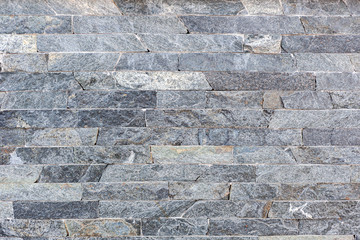 Gray Natural brick stone material texture background.