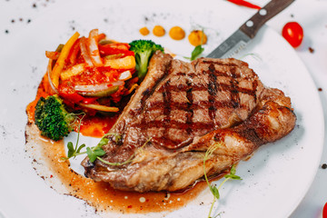 grilled beef steaks with spices isolated on white background