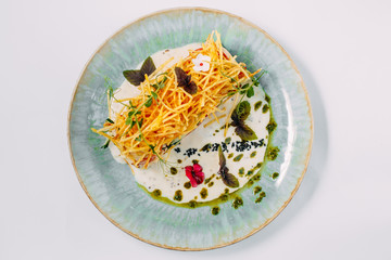 salad with french fries and sauce on a decorated white table