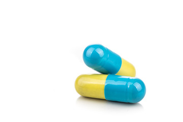 Close-up of two medicine in capsule format on white background