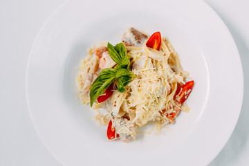 fettuccine pasta with red tomato fish and cheese
