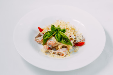 fettuccine pasta with red tomato fish and cheese