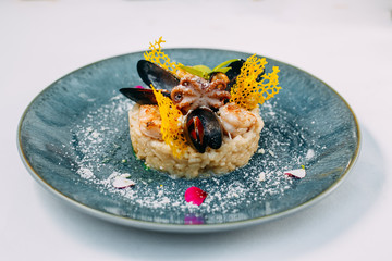 rice with seafood, mussels, shrimp and octopus on an isolated white background