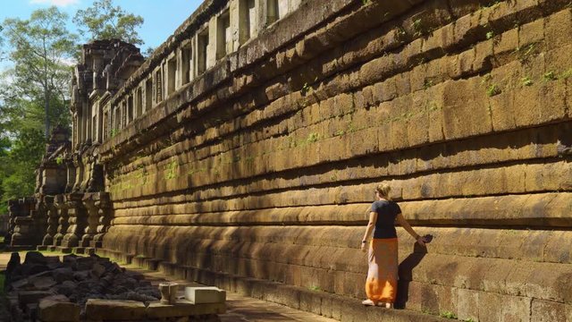 Young Caucasian Woman Walking Along Side of Ta Keo Temple in the Angkor Wat Complex, Siem Reap, Cambodia