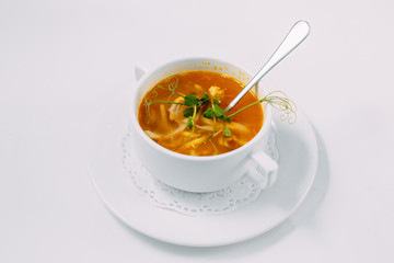 homemade chicken noodle soup isolated on a white background