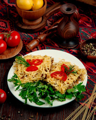 spaghetti with stuffed meat in sauce and tomatoes with herbs