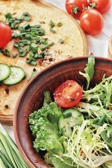 Dietary food background: vegetable salad with cherry tomatoes and cucumbers, vegan cuisine