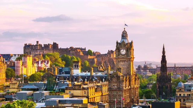 Edinburgh, UK. Aerial view of Edinburgh, Scotland. The city with Castle and Clock Tower during the evening. Cloudy sunset sky. Time-lapse at sunset, panning video