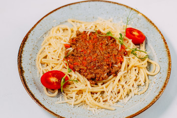 italian pasta bolognese with tomatoes and basil isolated on white background