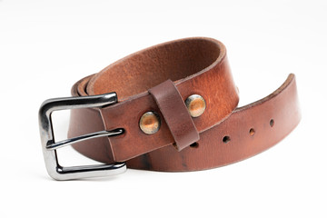 A formal studio product shot of a men’s used brown leather belt with patina set on plain white background.