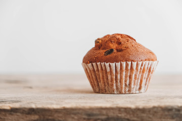 Chocolate cupcake on wooden table background. Copy, empty space for text