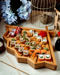 sushi rolls set place on fan shaped wooden sushi tray