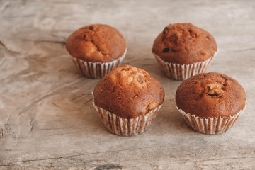 Chocolate cupcakes on wooden table background. Copy, empty space for text