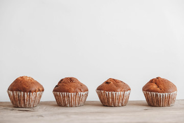Chocolate cupcakes on wooden table background. Copy, empty space for text