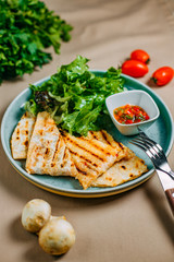 quesadilla with sauce and lettuce with vegetables on a decorated table
