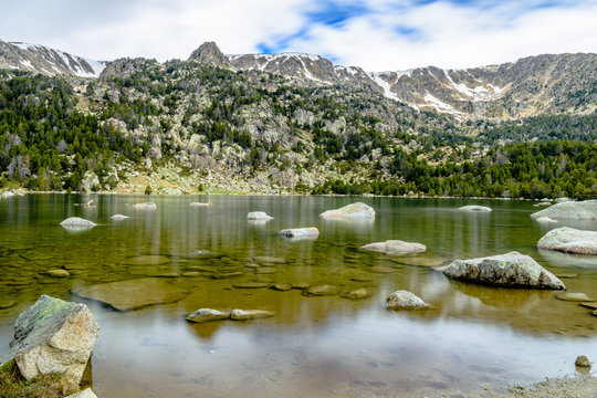 Snow mountains landscape at the Lake of Malniu, the Catalan Pyrenees Mountains (Spain)