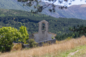 Small mountain chapel and a tree next to it, Saint-André-les-Alps, France