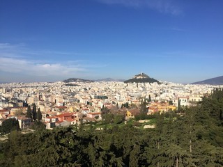 Fototapeta na wymiar Athens, Greece - 14th April 2018: City View and Scenery of the Acropolis in Athens, Greece. The Acropolis of Athens is an ancient citadel located on a rocky outcrop above the city of Athens