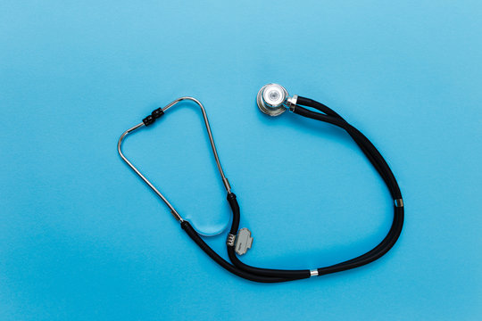 Stethoscope on a blue background, medical concept.