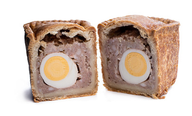 Traditional English savoury gala egg pork pie isolated on white