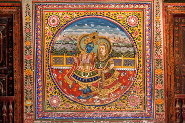 Fototapeta na wymiar Krishna and Radha wife, colorful fresco, interior of old house in Shekhawati region