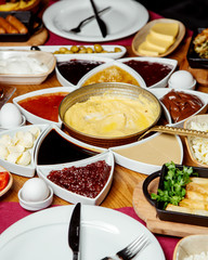 turkish breakfast setup with cheese jams egg dish chocolate butter and others