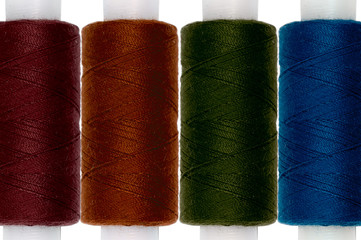 Directly Above Shot Of Colorful Spools Over White Background