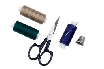 Items for sewing: needle, scissors, threads and thimble