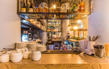 Bar counter with elite alcohol and clean dishes for tea
