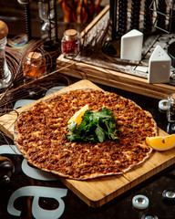 turkish pizza lahmajun topped with parsley and lemon