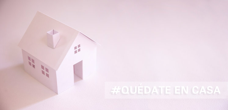 white paper house with text in spanish "quedate en casa" (stay at home)  with copy space. Social distancing campaign during pandemic