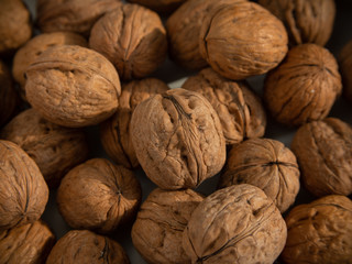 Walnut background, scattered pile of walnuts.