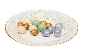 Easter eggs and candy on the saucer